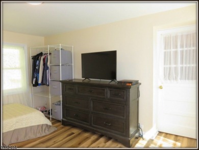 Completely renovated in 2020 this year round home sits on the on Lake Lackawanna Golf Course in New Jersey - for sale on GolfHomes.com, golf home, golf lot