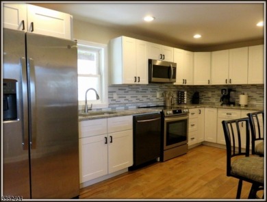 Completely renovated in 2020 this year round home sits on the on Lake Lackawanna Golf Course in New Jersey - for sale on GolfHomes.com, golf home, golf lot