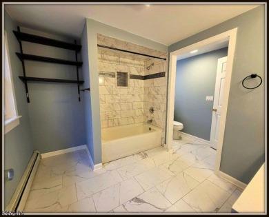 Completely renovated in 2020 this year round home sits on the on Lake Lackawanna Golf Course in New Jersey - for sale on GolfHomes.com, golf home, golf lot