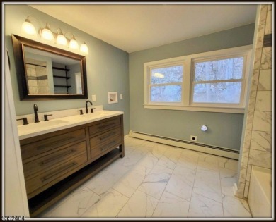 Completely renovated in 2020 this year round home sits on the on Lake Lackawanna Golf Course in New Jersey - for sale on GolfHomes.com, golf home, golf lot