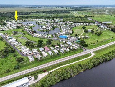 Discover resort-style living on the scenic shores of Lake on Blue Cypress Golf and RV Resort in Florida - for sale on GolfHomes.com, golf home, golf lot