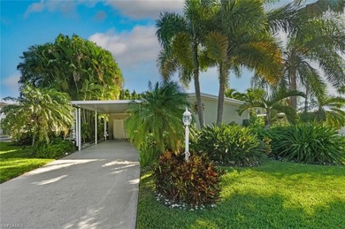This tropical oasis features an updated interior, lush on Riviera Golf Club in Florida - for sale on GolfHomes.com, golf home, golf lot