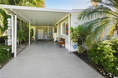 This tropical oasis features an updated interior, lush on Riviera Golf Club in Florida - for sale on GolfHomes.com, golf home, golf lot