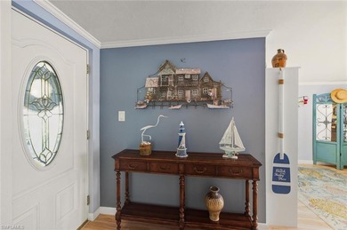 This tropical oasis features an updated interior, lush on Riviera Golf Club in Florida - for sale on GolfHomes.com, golf home, golf lot