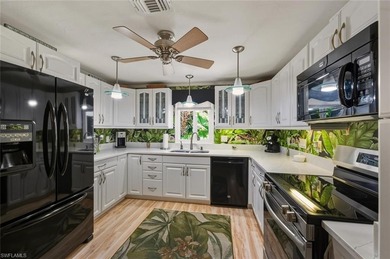 This tropical oasis features an updated interior, lush on Riviera Golf Club in Florida - for sale on GolfHomes.com, golf home, golf lot