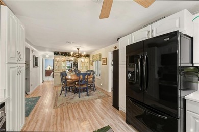 This tropical oasis features an updated interior, lush on Riviera Golf Club in Florida - for sale on GolfHomes.com, golf home, golf lot