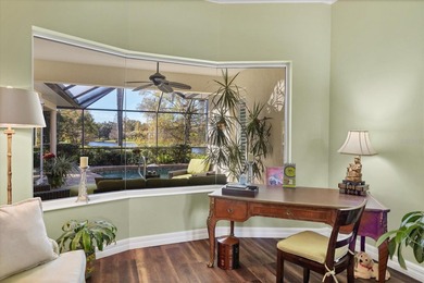 A captivating lake view with mature trees draws you in the on Legacy Golf Club in Florida - for sale on GolfHomes.com, golf home, golf lot