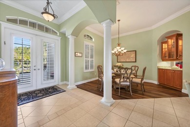 A captivating lake view with mature trees draws you in the on Legacy Golf Club in Florida - for sale on GolfHomes.com, golf home, golf lot