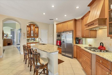 A captivating lake view with mature trees draws you in the on Legacy Golf Club in Florida - for sale on GolfHomes.com, golf home, golf lot