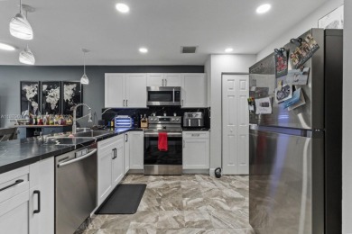 Affordable and stylishly renovated waterfront townhouse in the on Woodmont Country Club in Florida - for sale on GolfHomes.com, golf home, golf lot
