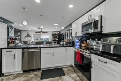Affordable and stylishly renovated waterfront townhouse in the on Woodmont Country Club in Florida - for sale on GolfHomes.com, golf home, golf lot