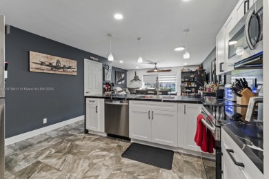 Affordable and stylishly renovated waterfront townhouse in the on Woodmont Country Club in Florida - for sale on GolfHomes.com, golf home, golf lot