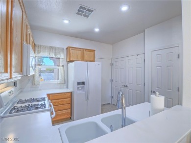 From the moment you enter the gated courtyard, you're greeted on Aliante Golf Club in Nevada - for sale on GolfHomes.com, golf home, golf lot