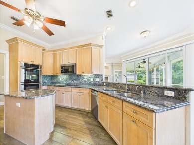 Situated on an oversized lot and a half, this beautifully on Fairway Oaks at Magnolia Golf Course in Florida - for sale on GolfHomes.com, golf home, golf lot