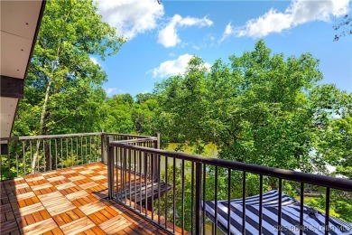 This magnificent 5-bedroom, 3-bathroom lakefront home is walking on The Oaks Golf Course in Missouri - for sale on GolfHomes.com, golf home, golf lot