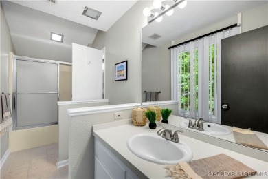 This magnificent 5-bedroom, 3-bathroom lakefront home is walking on The Oaks Golf Course in Missouri - for sale on GolfHomes.com, golf home, golf lot