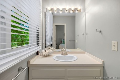 This magnificent 5-bedroom, 3-bathroom lakefront home is walking on The Oaks Golf Course in Missouri - for sale on GolfHomes.com, golf home, golf lot