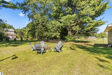 This four bedroom house with a double lot checks all the boxes on Elk Rapids Golf Club in Michigan - for sale on GolfHomes.com, golf home, golf lot