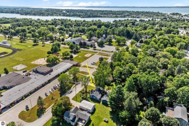 This four bedroom house with a double lot checks all the boxes on Elk Rapids Golf Club in Michigan - for sale on GolfHomes.com, golf home, golf lot