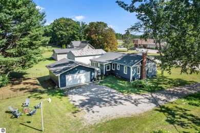 This four bedroom house with a double lot checks all the boxes on Elk Rapids Golf Club in Michigan - for sale on GolfHomes.com, golf home, golf lot