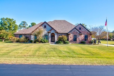 This custom brick & stone home sits on the #11 tee box and has on Lake Kiowa Golf Course in Texas - for sale on GolfHomes.com, golf home, golf lot