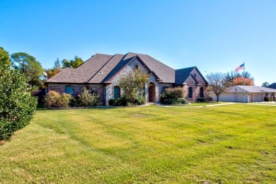 This custom brick & stone home sits on the #11 tee box and has on Lake Kiowa Golf Course in Texas - for sale on GolfHomes.com, golf home, golf lot