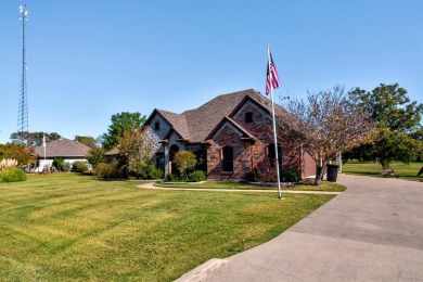 This custom brick & stone home sits on the #11 tee box and has on Lake Kiowa Golf Course in Texas - for sale on GolfHomes.com, golf home, golf lot