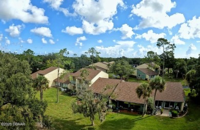 Nestled in the highly sought-after Sugar Mill Golf Townhomes on Sugar Mill Country Club in Florida - for sale on GolfHomes.com, golf home, golf lot