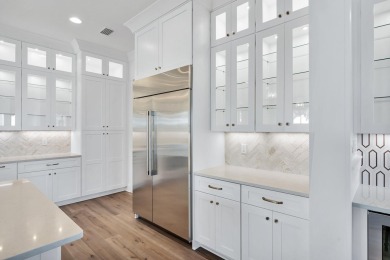 This thoughtfully designed expanded Coral Bean plan by Huff on Origins Golf Club in Florida - for sale on GolfHomes.com, golf home, golf lot