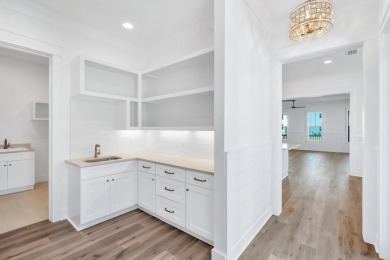 This thoughtfully designed expanded Coral Bean plan by Huff on Origins Golf Club in Florida - for sale on GolfHomes.com, golf home, golf lot