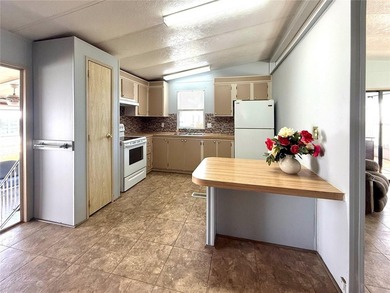 This very affordable two bedroom, two bathroom home is located on Apollo Beach Golf and Sea Club in Florida - for sale on GolfHomes.com, golf home, golf lot