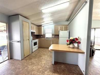 This very affordable two bedroom, two bathroom home is located on Apollo Beach Golf and Sea Club in Florida - for sale on GolfHomes.com, golf home, golf lot