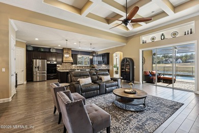 Stunning pool home with a pond to golf course view in gated on Magnolia Point Golf and Country Club in Florida - for sale on GolfHomes.com, golf home, golf lot