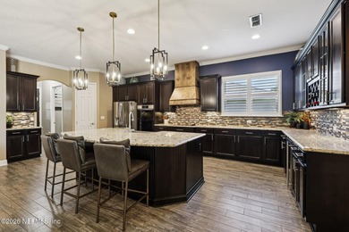 Stunning pool home with a pond to golf course view in gated on Magnolia Point Golf and Country Club in Florida - for sale on GolfHomes.com, golf home, golf lot