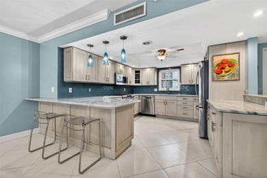 Welcome to waterfront living at its finest in Point Brittany; on Isla Del Sol Yacht and Country Club in Florida - for sale on GolfHomes.com, golf home, golf lot