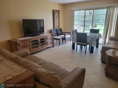 ELEGANT, IMMACULATE AND SPACIOUS UNIT WITH SERENE VIEWS OF GOLF on Wynmoor Golf Course in Florida - for sale on GolfHomes.com, golf home, golf lot