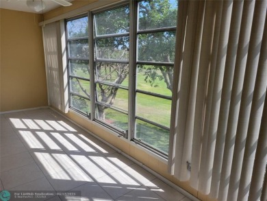 ELEGANT, IMMACULATE AND SPACIOUS UNIT WITH SERENE VIEWS OF GOLF on Wynmoor Golf Course in Florida - for sale on GolfHomes.com, golf home, golf lot