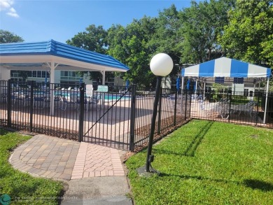 ELEGANT, IMMACULATE AND SPACIOUS UNIT WITH SERENE VIEWS OF GOLF on Wynmoor Golf Course in Florida - for sale on GolfHomes.com, golf home, golf lot