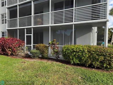 Convenient first floor unit condo in the tropical Palm Aire on Palm-Aire Country Club and Resort - The Oaks in Florida - for sale on GolfHomes.com, golf home, golf lot