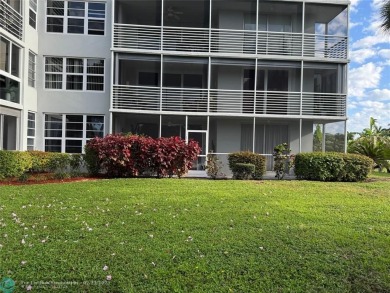 Convenient first floor unit condo in the tropical Palm Aire on Palm-Aire Country Club and Resort - The Oaks in Florida - for sale on GolfHomes.com, golf home, golf lot
