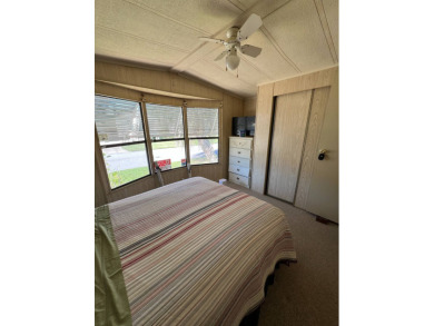 Cozy furnished home with no rear neighbors, ready for you to on Lake Henry Golf Club in Florida - for sale on GolfHomes.com, golf home, golf lot