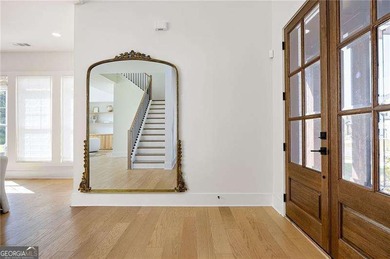 Welcome home to this executive home built by the Toll Brothers on Capital City Club Crabapple in Georgia - for sale on GolfHomes.com, golf home, golf lot