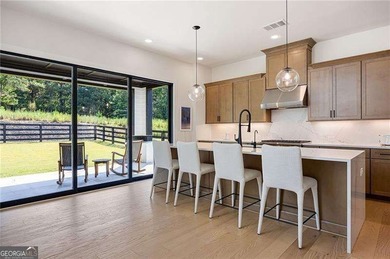 Welcome home to this executive home built by the Toll Brothers on Capital City Club Crabapple in Georgia - for sale on GolfHomes.com, golf home, golf lot