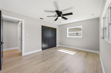 Welcome to this beautifully remodeled 3 bedroom, 2 bathroom pool on Mangrove Bay Golf Course in Florida - for sale on GolfHomes.com, golf home, golf lot