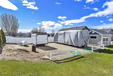 This stunning property offers an 18-ft garage door with an RV on River Bend Golf Course in Idaho - for sale on GolfHomes.com, golf home, golf lot