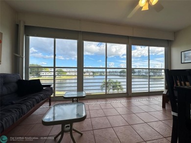 WATER VIEW! Indulge in this luxury 2 bed, 2 bath condo nestled on Hillsboro Pines Golf in Florida - for sale on GolfHomes.com, golf home, golf lot