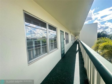 WATER VIEW! Indulge in this luxury 2 bed, 2 bath condo nestled on Hillsboro Pines Golf in Florida - for sale on GolfHomes.com, golf home, golf lot