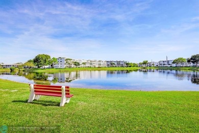 WATER VIEW! Indulge in this luxury 2 bed, 2 bath condo nestled on Hillsboro Pines Golf in Florida - for sale on GolfHomes.com, golf home, golf lot