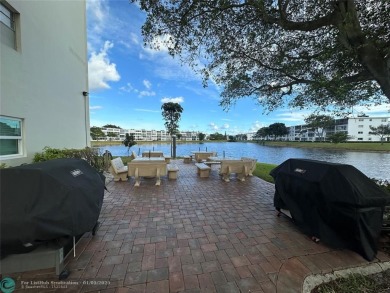 WATER VIEW! Indulge in this luxury 2 bed, 2 bath condo nestled on Hillsboro Pines Golf in Florida - for sale on GolfHomes.com, golf home, golf lot