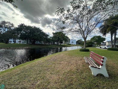 WATER VIEW! Indulge in this luxury 2 bed, 2 bath condo nestled on Hillsboro Pines Golf in Florida - for sale on GolfHomes.com, golf home, golf lot